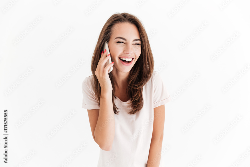 Pretty laughing woman talking by the smartphone and looking away Pretty laughing woman talking by the smartphone and looking away