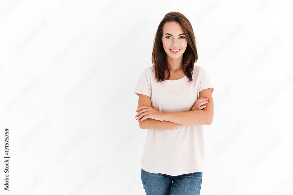 Smiling beauty woman with crossed arms looking at the camera Smiling beauty woman with crossed arms looking at the camera