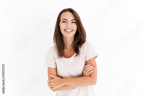 Laighing woman with crossed arms looking at the camera