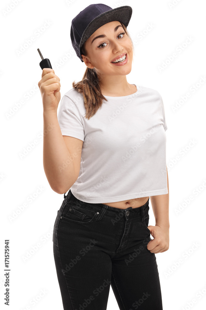 Teenage girl holding a car key and smiling