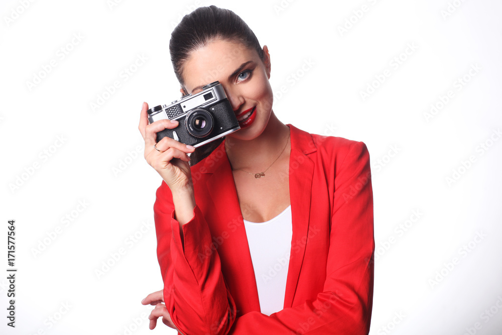 Young woman is posing with old camera Young woman is posing with old camera