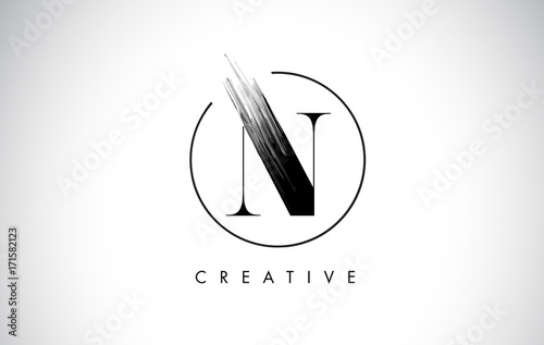 N Brush Stroke Letter Logo Design. Black Paint Logo Leters Icon. photo