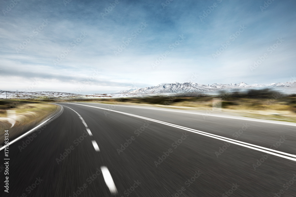 empty asphalt road with snow mountains in blue sky