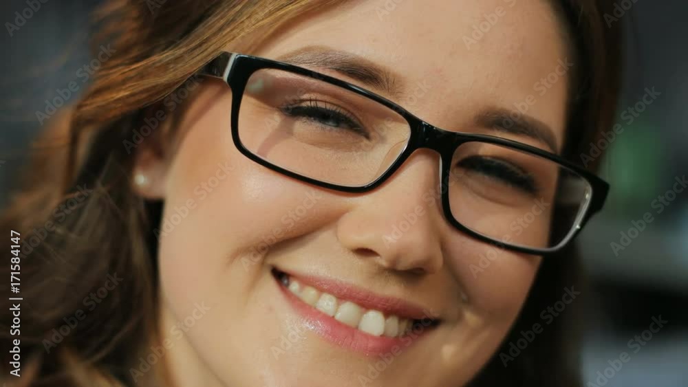 Close up portrait of beautiful happy woman in the glasses smiling at the camera on the living room background. Close up portrait of beautiful happy woman in the glasses smiling at the camera on the living room background.