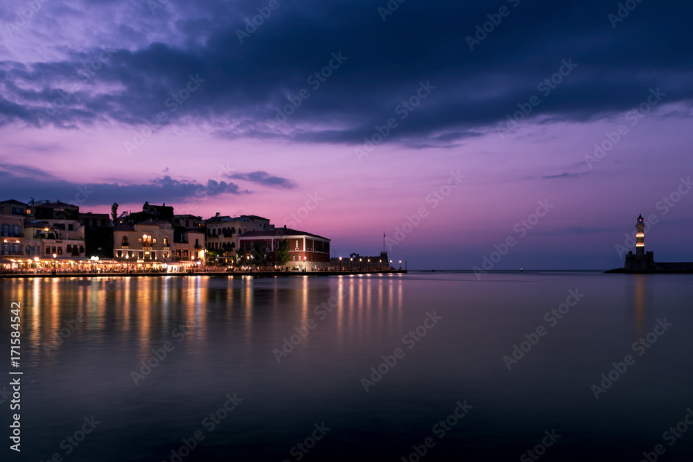 Chania, Crete, Greece: lighthouse in Venetian harbor at blue hour