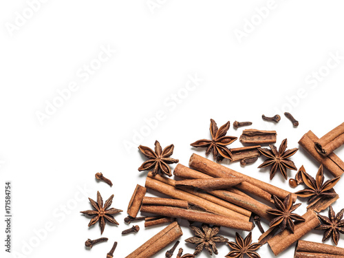 Fototapeta Naklejka Na Ścianę i Meble -  Winter spices background. Cinnamon, cloves and star anise with copy space. Isolated on white with clipping path. Top view or flat lay. Winter food background concept.