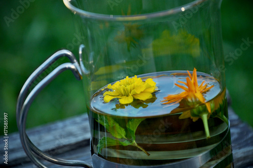 Cup of infusion of marigold with Calendula flowers and mint 