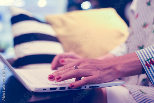 Closeup on sitting woman use laptop for business  creative project  researching study working process. Modern networking communication technology  abstract office indoors background. Content creation