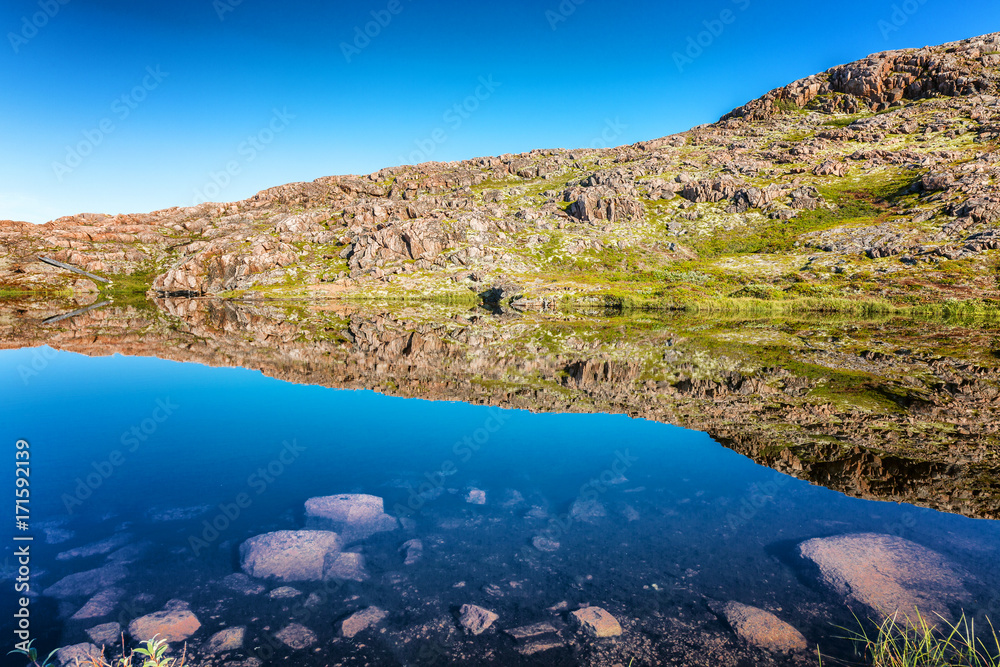 beautiful mountain lake, mirror water surface, blue sky beautiful mountain lake, mirror water surface, blue sky