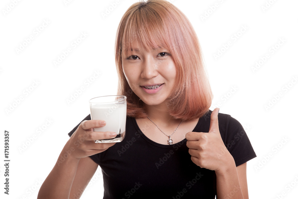 Healthy Asian woman drinking a glass of milk thumbs up. Healthy Asian woman drinking a glass of milk thumbs up.