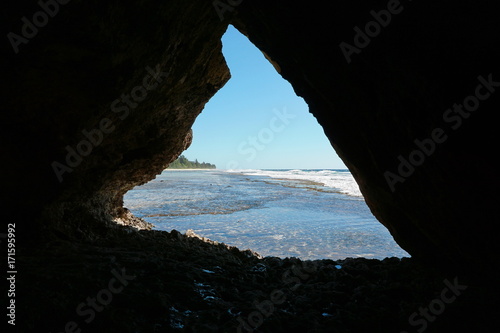 Sea shore seen from a small cavern in the rocks, Rurutu island, Pacific ocean, Austral archipelago, French Polynesia