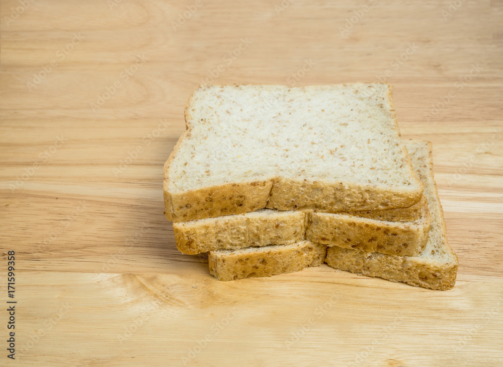 Three slice whole wheat bread on wooden table Three slice whole wheat bread on wooden table