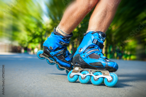 Closeup of Inline roller skater on a slalom course. photo