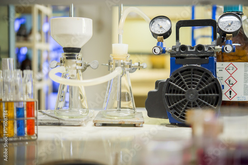 Chemical filtration with Buchner funnel bushings using a vacuum pump, in chemical laboratories. © Prajakkit