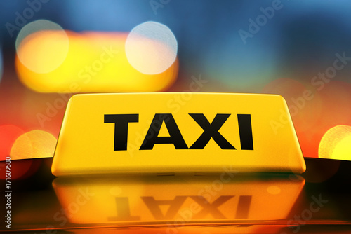 3d rendering Yellow taxi sign on the roof of car in a city street at night. Luminous neon taxi sign on bokeh big city background