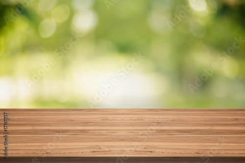 Wood table top on nature green blurred background,for montage your products