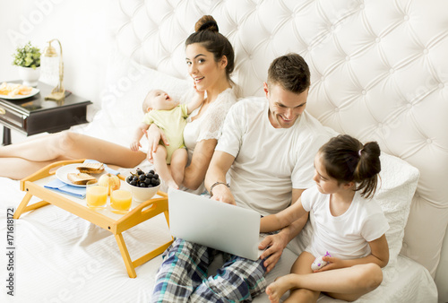 Young family with laptop in...