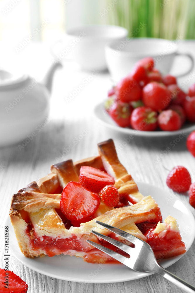 Plate with delicious piece of strawberry pie on wooden table Plate with delicious piece of strawberry pie on wooden table