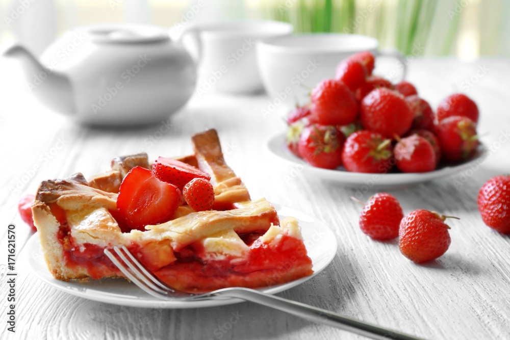 Plate with delicious piece of strawberry pie on wooden table Plate with delicious piece of strawberry pie on wooden table