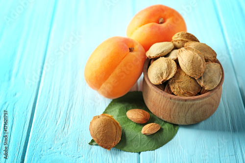 Apricots with kernels on wooden background