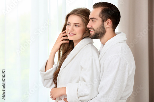 Young loving couple in bathrobes at home