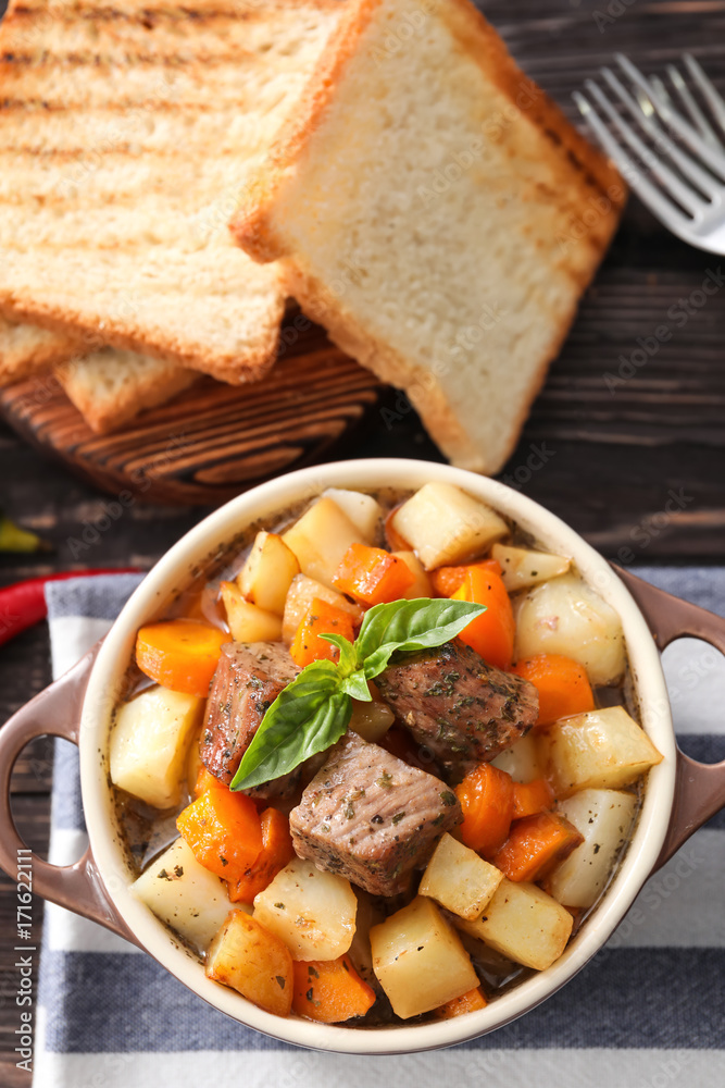 Casserole with tasty meat and potatoes on table