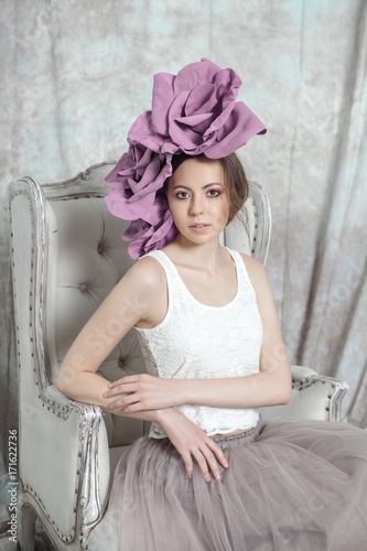 female sitting with big flowerr in her head photo