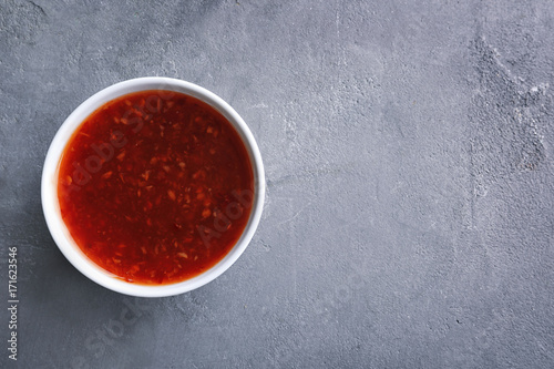 Chili sauce in bowl on table
