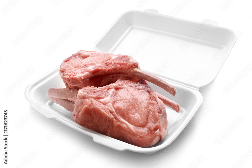Raw ribs in container on white background Raw ribs in container on white background