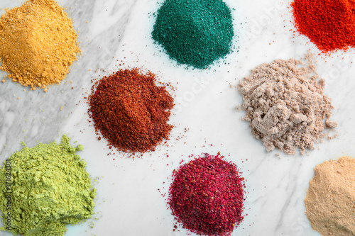 Various colorful superfood powders on light background photo