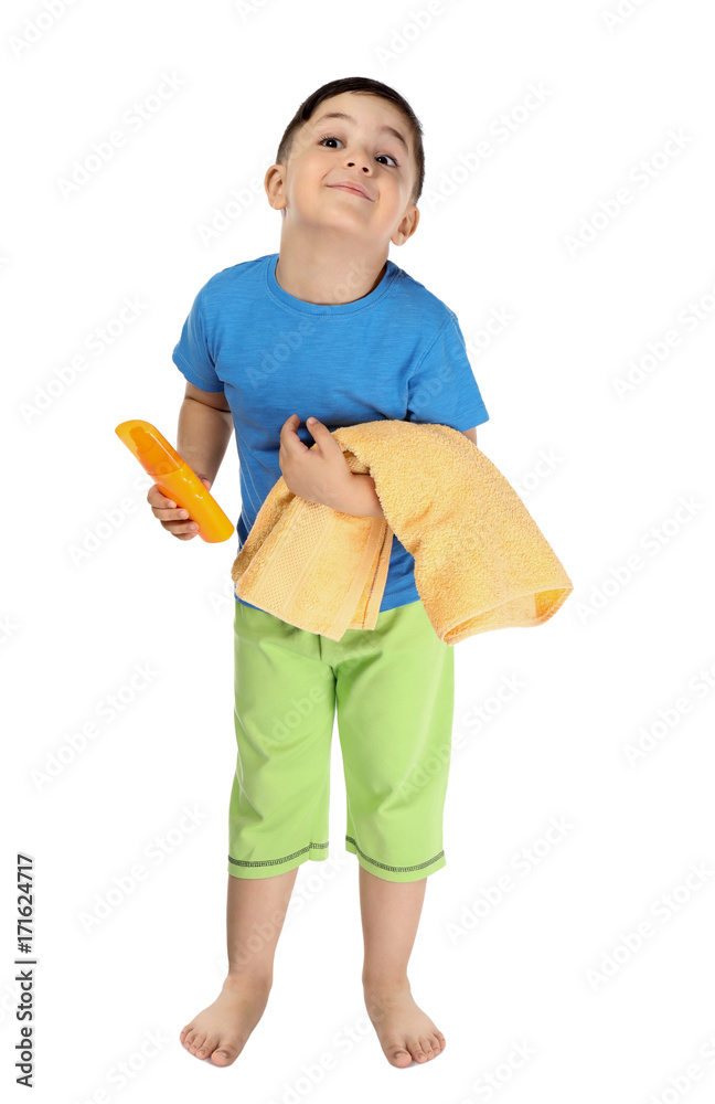 Cute little boy with sunscreen cream and towel on white background. Summer vacation concept Cute little boy with sunscreen cream and towel on white background. Summer vacation concept