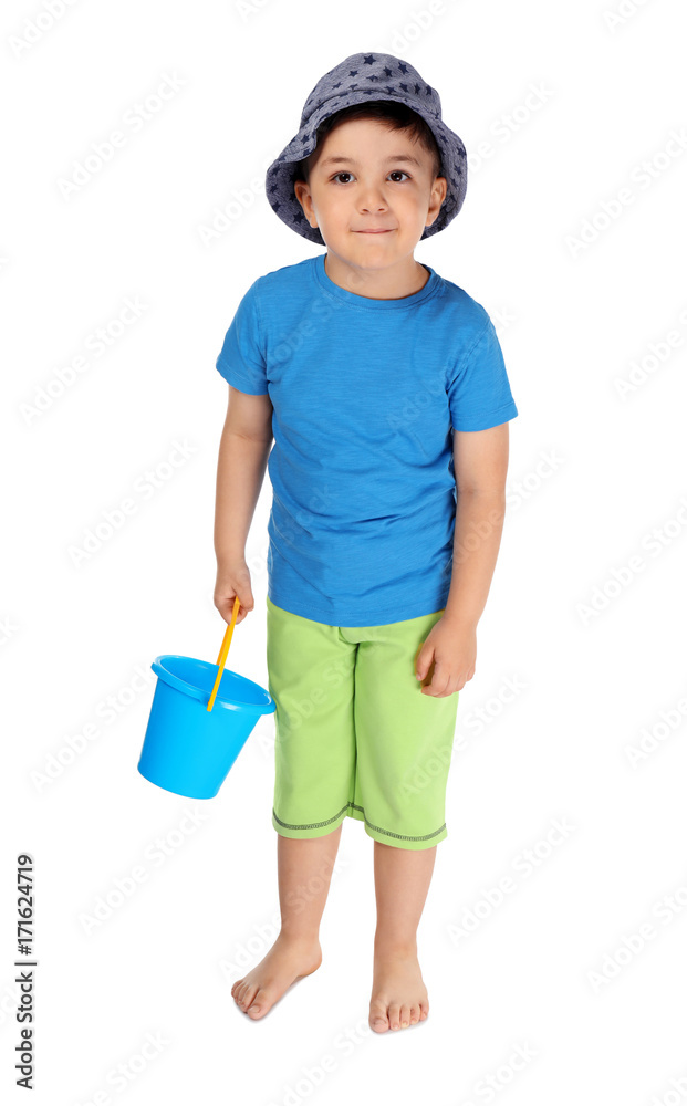 Cute little boy with plastic bucket on white background. Summer vacation concept Cute little boy with plastic bucket on white background. Summer vacation concept