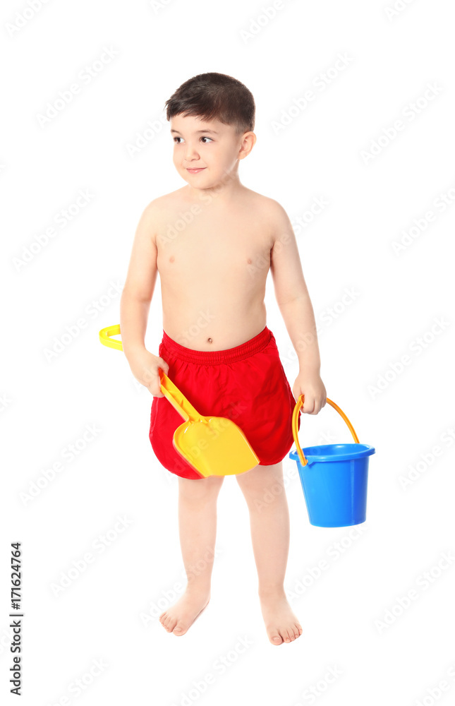 Cute little boy with plastic bucket and scoop on white background. Summer vacation concept Cute little boy with plastic bucket and scoop on white background. Summer vacation concept