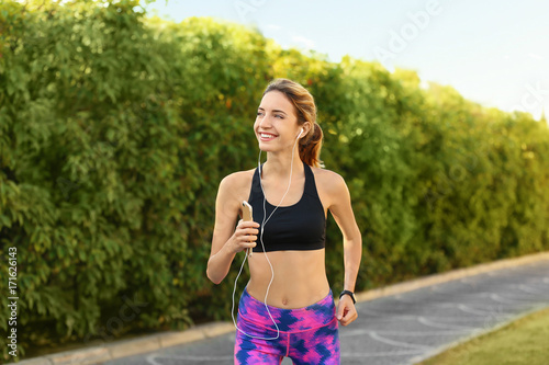 Young beautiful woman runni...
