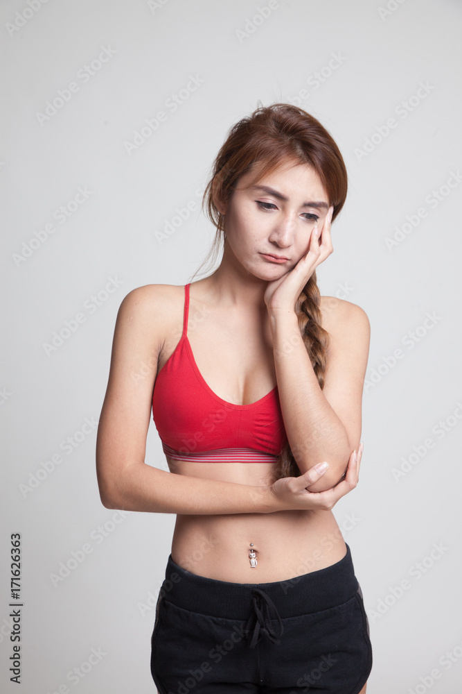 Beautiful young Asian woman in sport dress get bored. Beautiful young Asian woman in sport dress get bored.