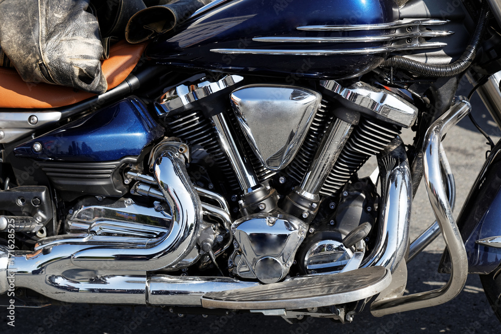 Closeup detail photo chrome engine and exhaust pipe of the motorcycle Closeup detail photo chrome engine and exhaust pipe of the motorcycle