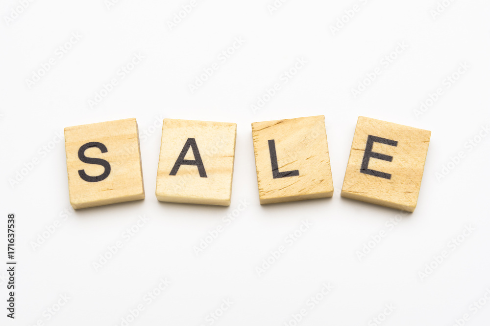 Sale word on scrabble wooden tiles isolated on white background Sale word on scrabble wooden tiles isolated on white background
