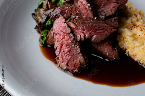 Beef ribeye deckle cooked medium rare with sauce and sides photo