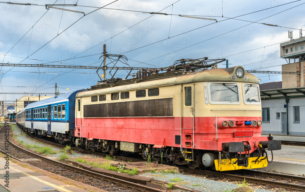 Old electric locomotive with a passenger train at Brno station, Czech Republic