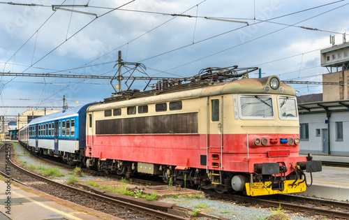 Old electric locomotive with a passenger train at Brno station, Czech Republic