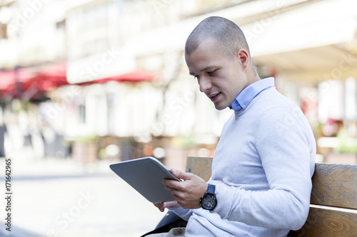He uses a tablet on the street