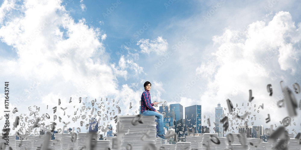 Attractive man sitting on pile of paper documents. Attractive man sitting on pile of paper documents.