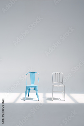 Two different chairs in the whtie studio