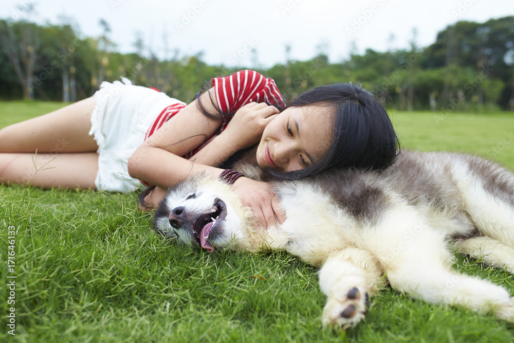 happy little asian girl with her dog outdoor happy little asian girl with her dog outdoor