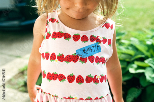 little girl with name tag in childs handwriting