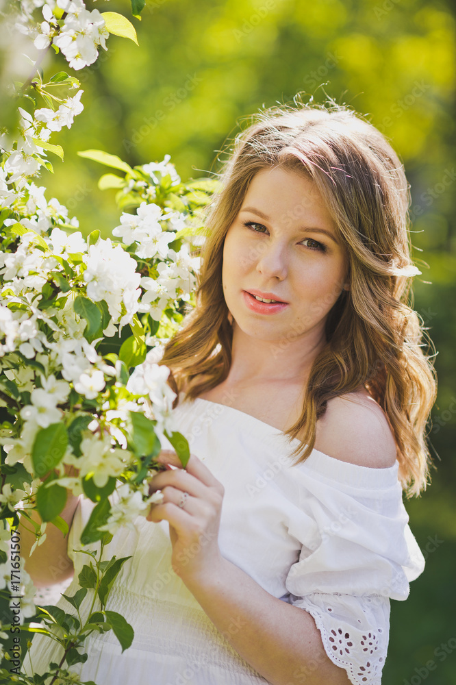 A pregnant woman walks in the flowered gardens 8233. A pregnant woman walks in the flowered gardens 8233.