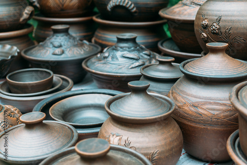 Many handmade brown clay pots, bowls, mugs