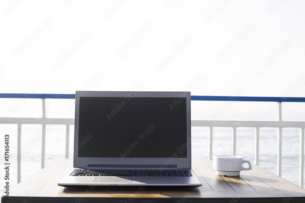 workplace on the beach. computer with a black screen on the desk workplace on the beach. computer with a black screen on the desk