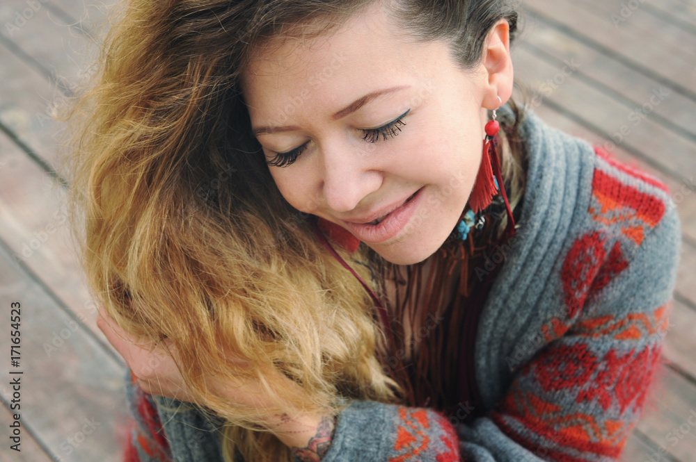 Beautiful smiling woman portrait dressed in gray knitted jersey Beautiful smiling woman portrait dressed in gray knitted jersey