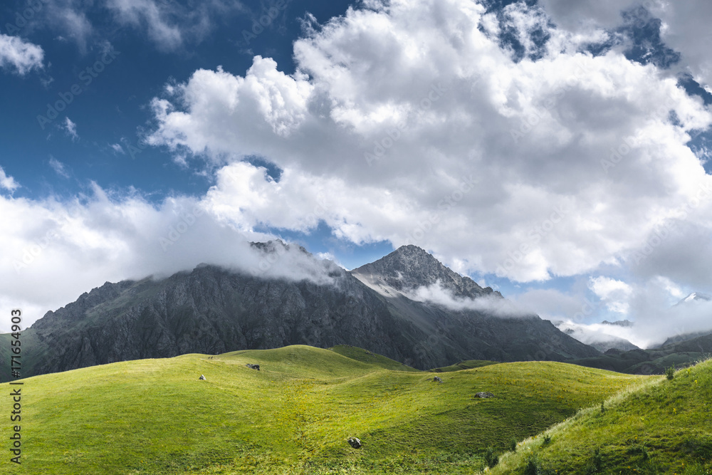 Picturesque Green Hills, Meadow And Mountains In The Clouds. Elbrus, North Caucasus, Russia